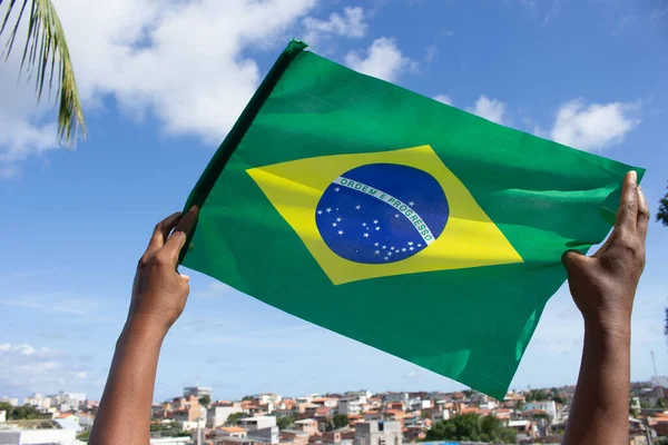 Man Holding Brazilian Flag Front Community — стокове фото