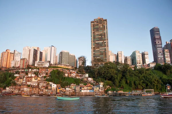 SALVADOR, BRASIL - JULY 30, 2022 : view of several buildings and houses close and several boats in high city of Salvador