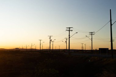 several power poles in the late afternoon