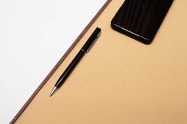 smartphone and clipboard on office table