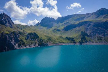 Aerial shot of the Luenersee with dam wall and rocks in Vorarlberg, Austria