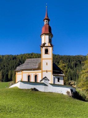 Ormanın yakınındaki yeşil çimenlikteki güzel kilise