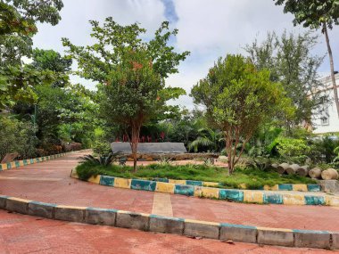 Güzel halka açık sabah ve akşama yakın park içinde yürüyüş yolları iyi bakımlı, kaya veya taş sandalyeler Bangalore şehrinde oturmak için