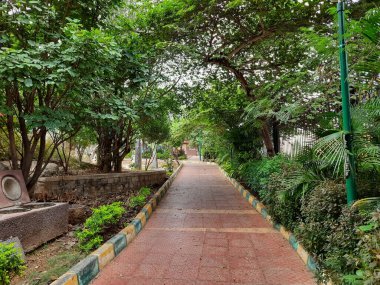 Güzel halka açık sabah ve akşama yakın park içinde yürüyüş yolları iyi bakımlı, kaya veya taş sandalyeler Bangalore şehrinde oturmak için