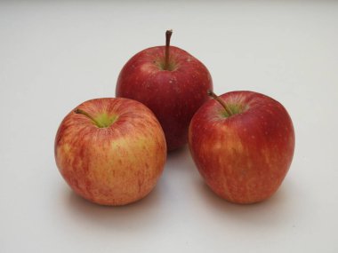 Hint grubuna yakın çekim ve beyaz arkaplanda izole edilmiş tek elmalar