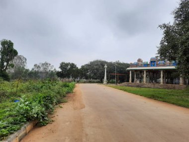 Bangalore, Karnataka, India-Dec 15, 2021: Closeup of beautiful asphalt and sand road in a rural with nature background