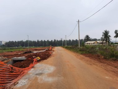 Bangalore, Karnataka, India-Dec 15, 2021: Closeup of beautiful asphalt and sand road in a rural with nature background