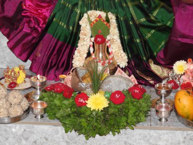 Bangalore, Karnataka, India-July 31, 2020: Beautiful puja decoration of Goddess Vara Mahalakshimi statue or kalash with different types of flower and fruits during festival.