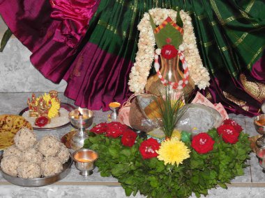 Bangalore, Karnataka, India-July 31, 2020: Beautiful puja decoration of Goddess Vara Mahalakshimi statue or kalash with different types of flower and fruits during festival.