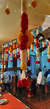 Bangalore, Karnataka, India-Oct 18, 2020: Closeup of Marriage hall decorated with colorful garland and hindu tamil traditional puja arrangement.