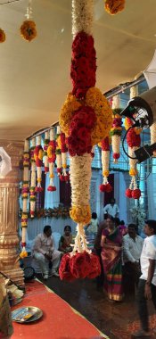 Bangalore, Karnataka, India-Oct 18, 2020: Closeup of Marriage hall decorated with colorful garland and hindu tamil traditional puja arrangement.