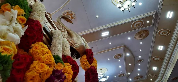Bangalore, Karnataka, India-Oct 18, 2020: Closeup of Marriage hall decorated with colorful garland and hindu tamil traditional puja arrangement.