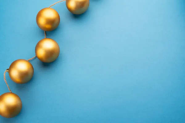 Gouden Kerstballen Een Lichtblauwe Achtergrond Bovenaanzicht — Stockfoto