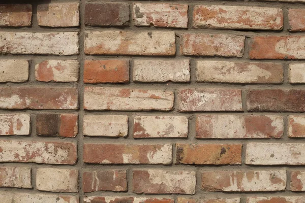 An old brick wall with a large frame, the background is yellow-hot