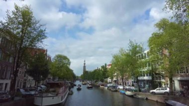  Yazın bulutlu bir günde Amsterdam 'da kumlu bir kanal manzarası