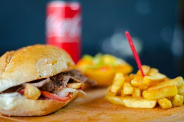 Meat doner kebab in sandwich bread. Traditional Turkish cuisine delicacies. Selective focus.