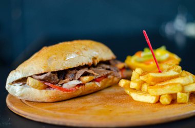 Meat doner kebab in sandwich bread. Traditional Turkish cuisine delicacies. Selective focus.