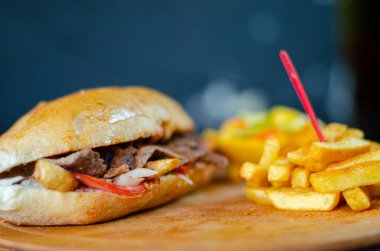 Meat doner kebab in sandwich bread. Traditional Turkish cuisine delicacies. Selective focus.