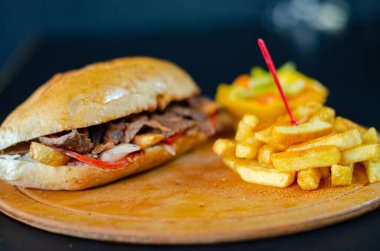 Meat doner kebab in sandwich bread. Traditional Turkish cuisine delicacies. Selective focus.