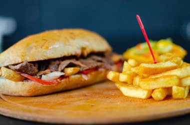 Meat doner kebab in sandwich bread. Traditional Turkish cuisine delicacies. Selective focus.