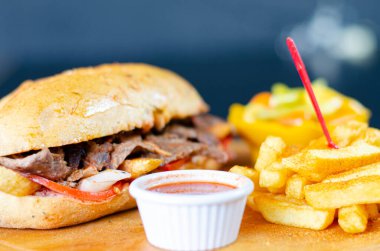 Meat doner kebab in sandwich bread. Traditional Turkish cuisine delicacies. Selective focus.