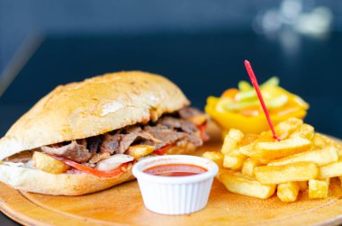 Meat doner kebab in sandwich bread. Traditional Turkish cuisine delicacies. Selective focus.