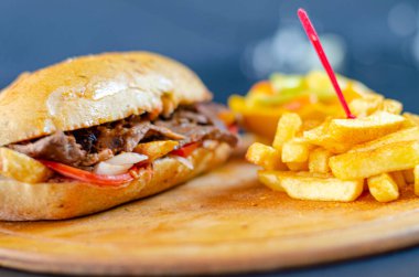 Meat doner kebab in sandwich bread. Traditional Turkish cuisine delicacies. Selective focus.