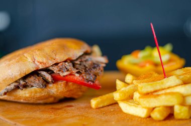 Meat doner kebab in sandwich bread. Traditional Turkish cuisine delicacies. Selective focus.