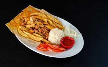 Chicken doner in plate. Chicken doner in porcelain plate isolated on black background. Delicious Turkish food doner. selective focus