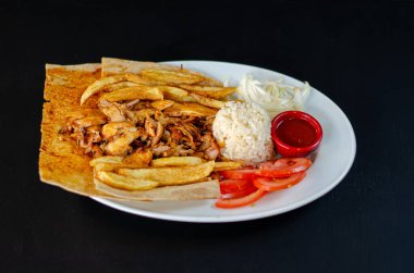 Chicken doner in plate. Chicken doner in porcelain plate isolated on black background. Delicious Turkish food doner. selective focus
