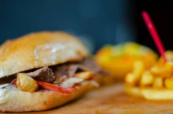 Meat doner kebab in sandwich bread. Traditional Turkish cuisine delicacies. Selective focus.