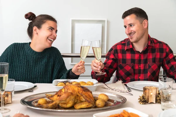 Mladý kavkazský pár připíjel se šampaňským na vánoční rodinnou večeři. Zamilovaný. — Stock fotografie
