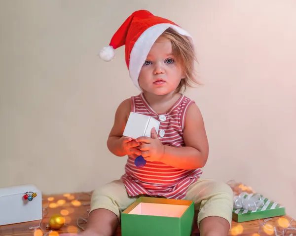 Criança Surpreso Confuso Chapéu Papai Noel Com Presentes — Fotografia de Stock