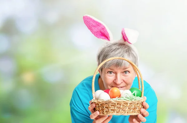 Senior Woman Peeking Out Basket Easter Eggs Natural Background — Zdjęcie stockowe