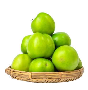 Fruit of green jojoba or plum in a straw basket isolated on white background