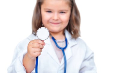Child in uniform doctor listens through stethoscope isolated on white background