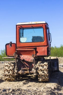 Mavi gökyüzüne karşı eski kırmızı buldozer. Arka plan.
