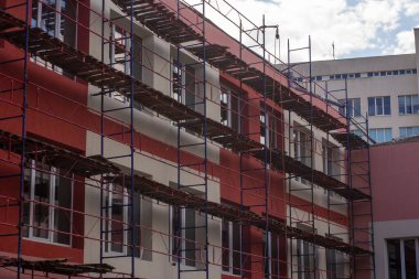 Scaffolding for painting the facade of a two-story house