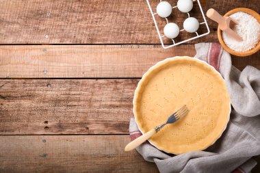 Balkabağı ve yiyecek malzemeleri, baharatlar, tarçın ve mutfak aletleri eski ahşap arka planda. Tatil için ev yapımı pişirme kavramı. Şükran Günü için balkabağı turtası ve kurabiye pişiriyorum..