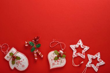 Noel çelengi, oyuncak ve hediye kutusu. Yeni yıl ya da noel dairesi noel kutlaması dekorasyonunun telif alanı olan kırmızı kağıt arka planında yatıyordu. Şablon düzenleme tebrik kartı tasarımı