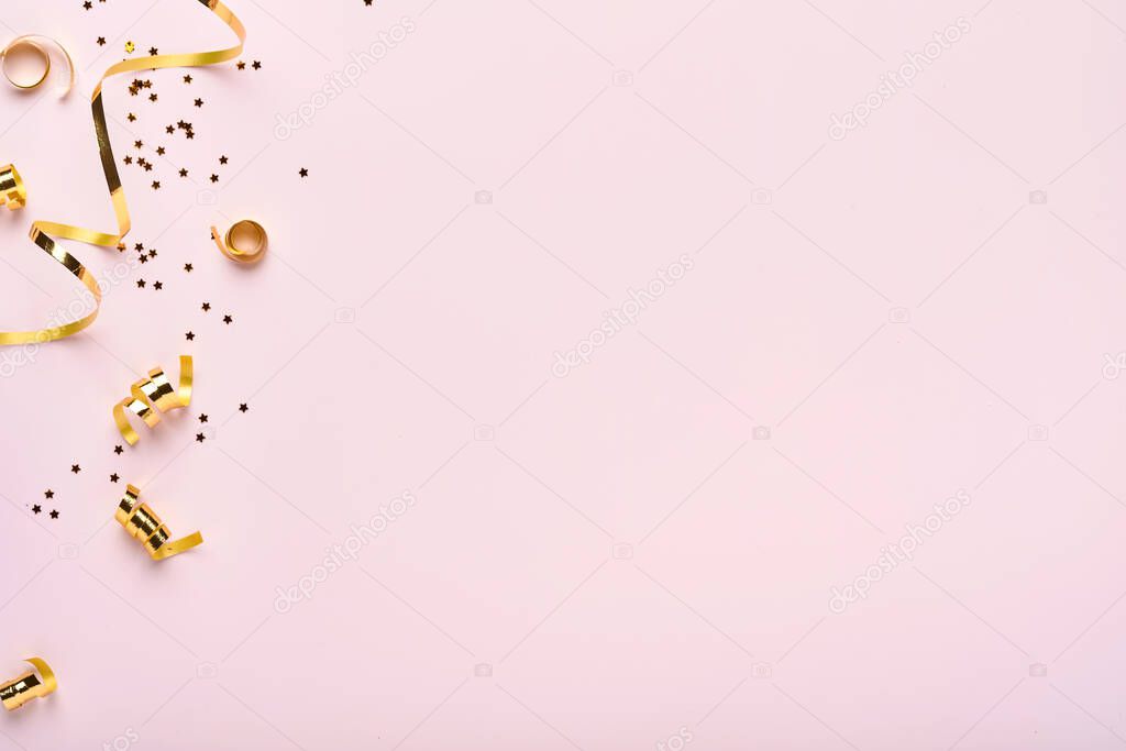 Christmas composition. Christmas pink gift or present box, gold baubles and confetti on pink background. Flat lay, top view. Magic Christmas greeting card. Border design. Mock up.
