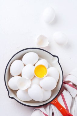 Beyaz arka planda demir kırmızısı tavada tavuk beyazı taze yumurta. Kapatın. Model.