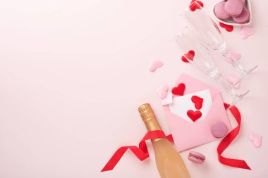 Sevgililer günü tebrik kartı şampanya şişesi, hediye kutusu, kırmızı kurdele ve içinde pembe arka planda boş notlar olan bir zarf. Selamlaşmak için en iyi manzara. Kopyalama alanı olan tebrik kartı
