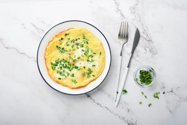 stock image Omelette or frittatas with green onions or young greenery and mozzarella on white marble table background. Healthy food concept. Breakfast. Copy space. Top view. Mock up.