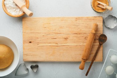 Beyaz arka plan manzaralı mutfak malzemeleri ve mutfak aletleri. Kalp şekeri kurabiyeleri hazırlanıyor. Pişirme arka planı. Un, yumurta, şeker, baharat ve mutfak masasına çırpı. Düz yatıyordu.