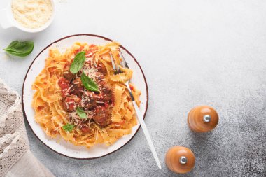 Domates soslu Tagliatelle makarnası ve açık gri kayrak, taş ya da beton arka planda kekik soslu. Geleneksel İtalyan yemeği ve mutfağı. Kopyalama alanı olan üst görünüm.