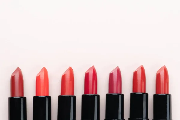 Red Lipsticks Different Shades Beige Background Makeup Cosmetics Concept Close — Stock Photo, Image