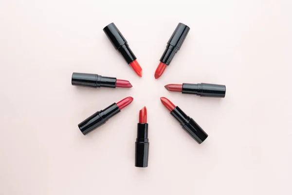 Red Lipsticks Different Shades Arranged Circle Beige Background Makeup Cosmetics — Stock Photo, Image