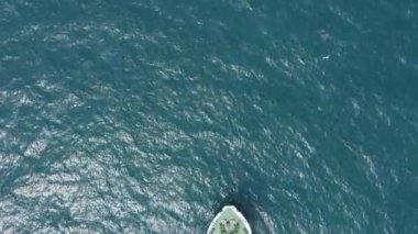 Cargo ship carries industrial metal pipes.