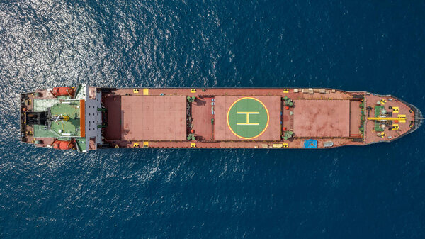 Cargo ship with a helicopter landing aboard. 